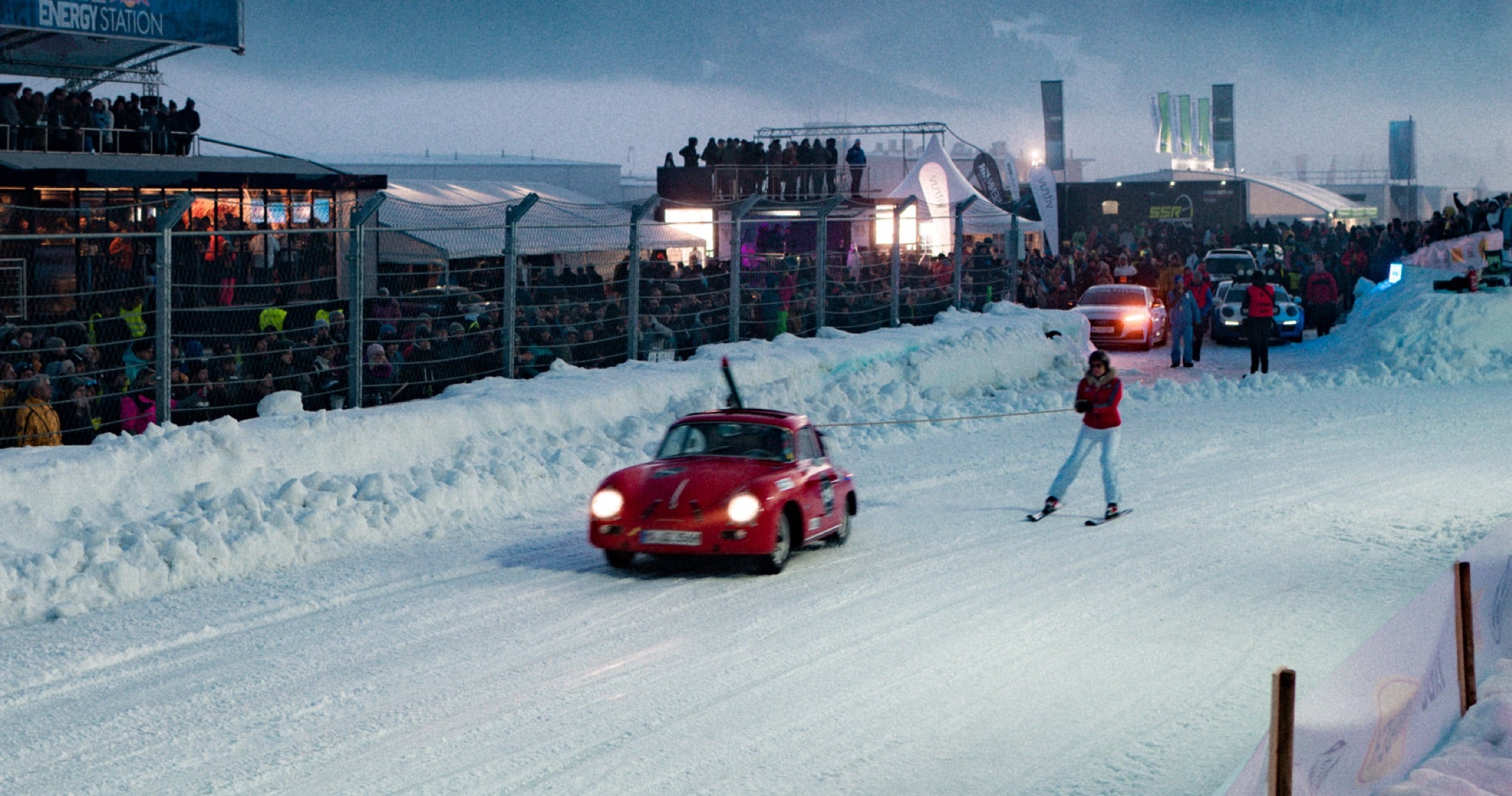 <span>Skijoring, the daredevil sport whereby skiers are towed behind racing cars, is one of the highlights at the Ice Race. Here, an intrepid participant is pulled by a vintage Porsche 356 at the 2020 race</span> <br/><span class="caption-sub"><em>Photo credit: F.A.T. International</em></span><br/>